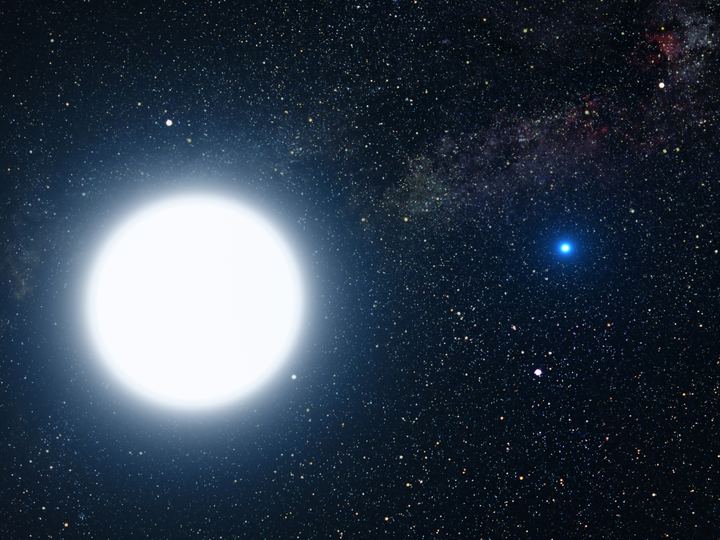 Artist's illustration of a large bright bluish white star with a small glowing blue companion star in the foreground against dark space