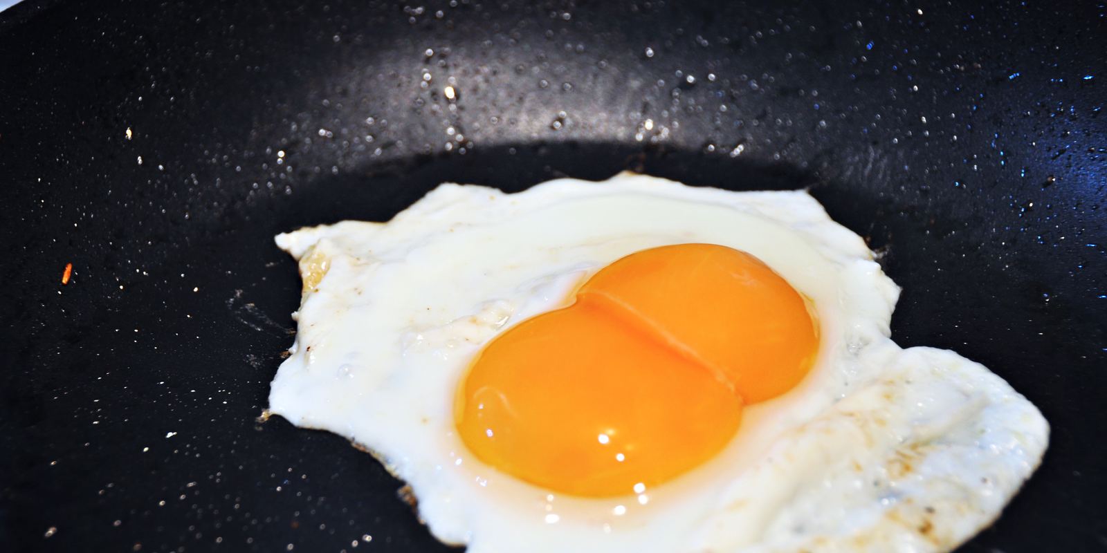 A fried egg with two yolks in a pan