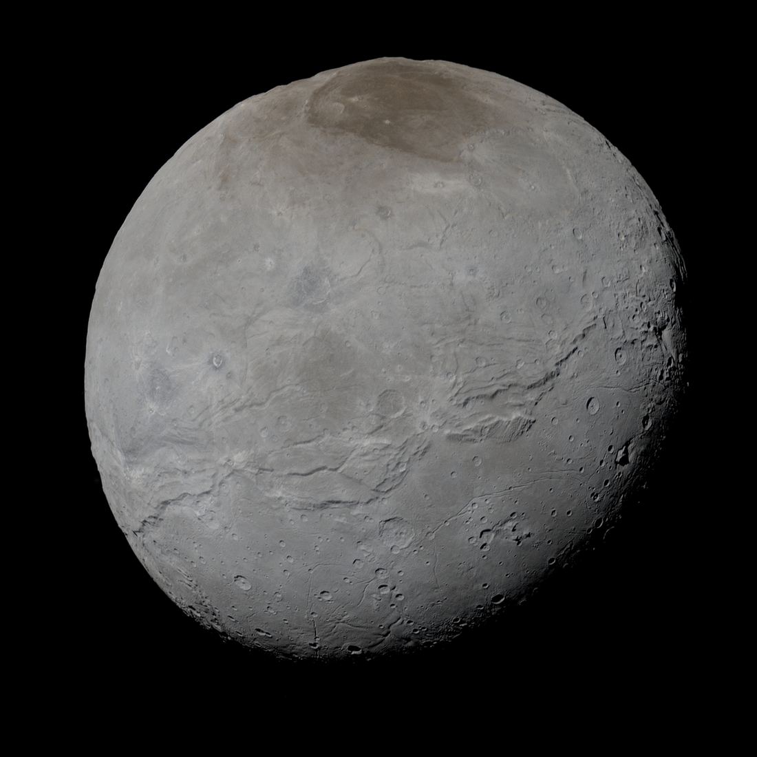 A detailed colour image of Pluto's moon Charon with its reddish polar cap
