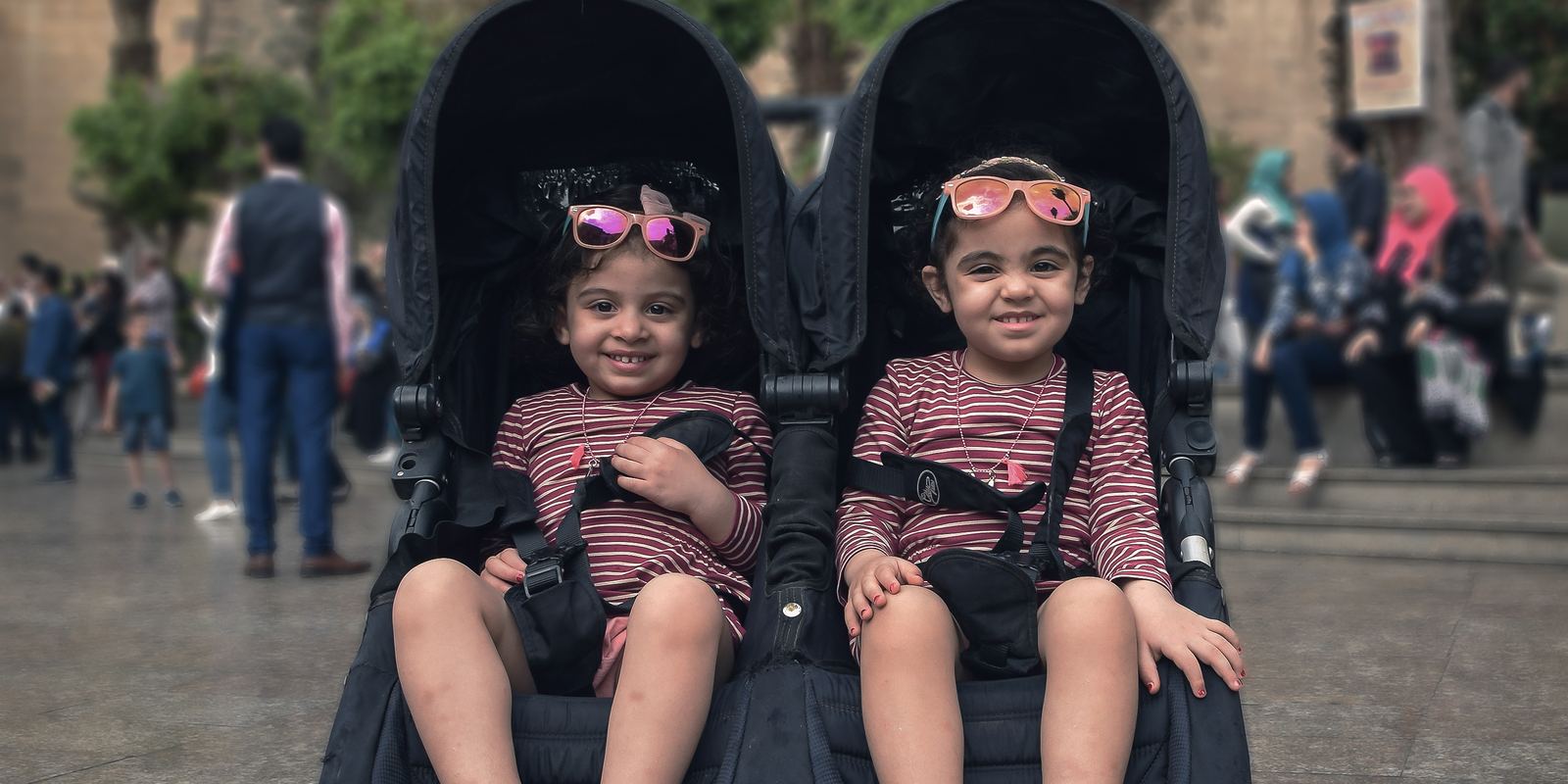 Two young twin girls sitting together